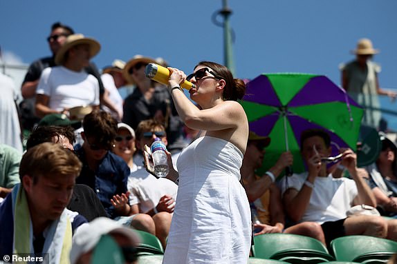 Tennis - Wimbledon - All England Lawn Tennis and Croquet Club, London, Britain - June 30, 2025 A spectator drinks water in the stands during the first round match between Russia's Daniil Medvedev and France's Benjamin Bonzi REUTERS/Isabel Infantes