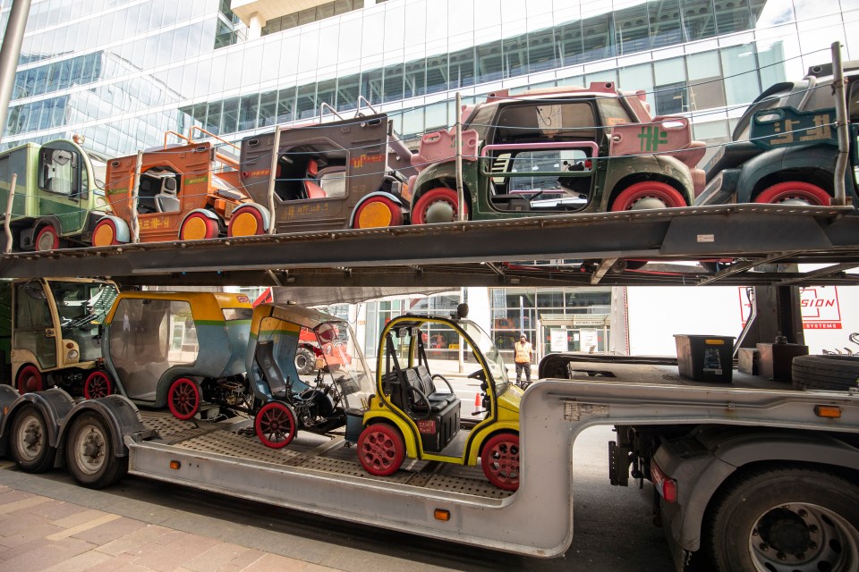 Film production vehicles on a flatbed truck.