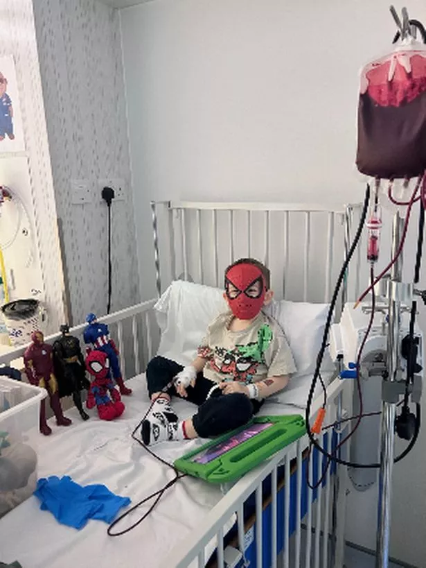 Isaac receiving a transfusion