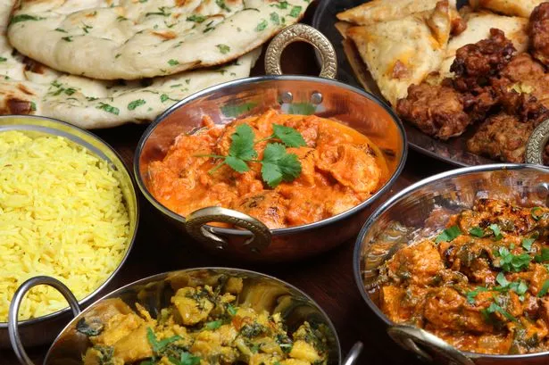 Stock image of Indian dishes and naan bread