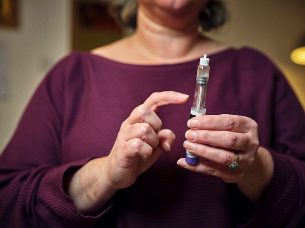 Woman holding weight loss injection