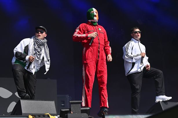 GLASTONBURY, ENGLAND - JUNE 28: Mo Chara, DJ Provaí and Móglaí Bap of Kneecap during day four of Glastonbury festival 2025 at Worthy Farm, Pilton on June 28, 2025 in Glastonbury, England. Established by Michael Eavis in 1970, Glastonbury has grown into the UK's largest music festival, drawing over 200,000 fans to enjoy performances across more than 100 stages. In 2026, the festival will take a fallow year, a planned pause to allow the Worthy Farm site time to rest and recover. (Photo by Leon Neal/Getty Images)