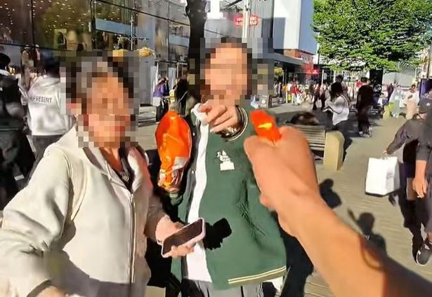 One video showed two women being approached and squirted with the toy gun