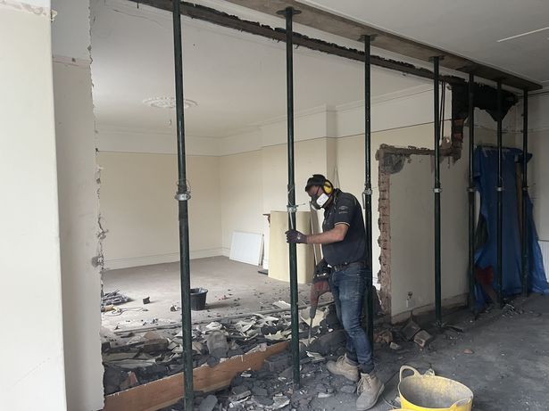 One of the team, Gary Dodd, taking down the structural wall between the two bedrooms in the former care home
