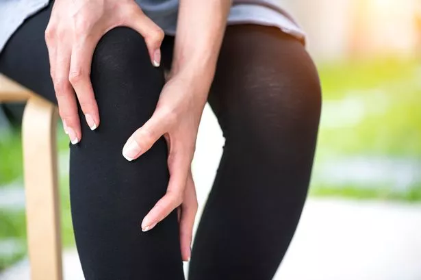 Hands suffering from pain in knee
