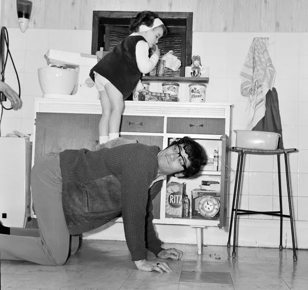Freddie Garrity, lead singer of the Manchester pop group Freddie and the Dreamers, playing with his three year old daughter Jackie. May 24, 1967