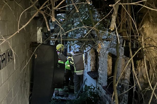 Firefighters search inside the Farriers Arms after the blaze
