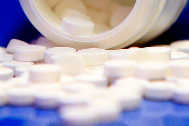 Close up of pills spilling out of a medicine bottle