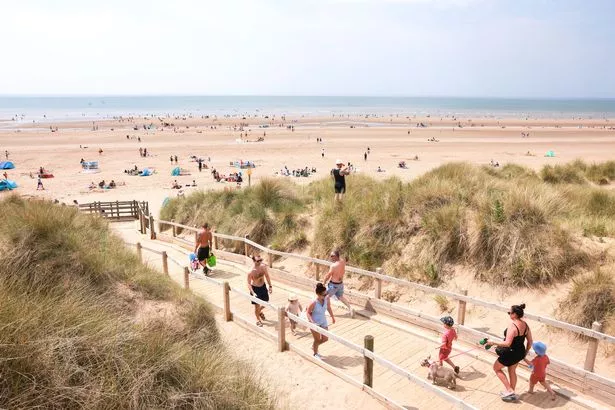 People enjoy the hot weather on Formby beach
