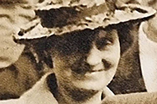 An old picture of a woman wearing a hat