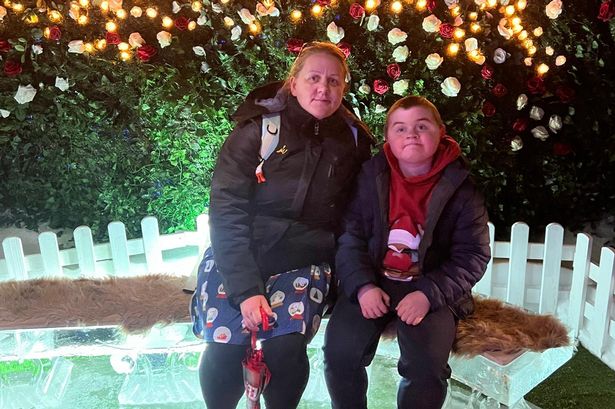 Rosemary Reid's son Harry (both pictured on a bench with a Christmas tree and lights behind) has Duchenne muscular dystrophy and she said: "Trying to explain to an 11-year-old that there was a new medicine that he can't have due to cost was he hardest thing to tell him"
