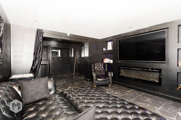 Lounge with black walls and furnishings