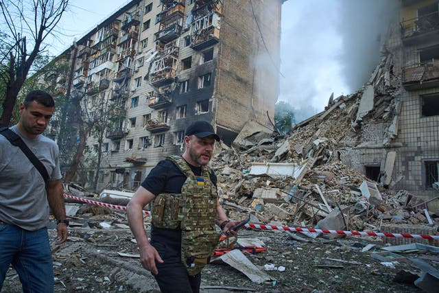 Interior minister Ihor Klymenko examines the site of a missile strike in Kyiv 