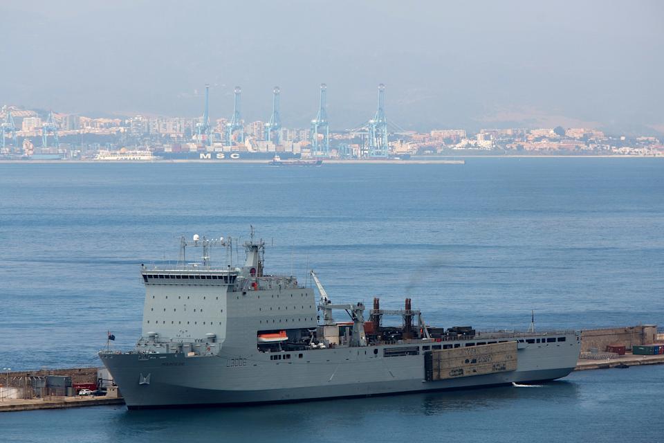 GIBRALTAR - AUGUST 19:  Royal Fleet Auxiliary ship RFA Mounts Bay is docked at Gibraltar military port, with the Spanish Port of Algeciras seen in the background, on August 19, 2013 in Gibraltar. Spanish fishermen held a protest yesterday at the site of an artificial reef, placed there by the Gibraltan government. Local fisherman claim the reef has had a negative impact on the Spanish fishing industry in the region, but Gibraltan officials insist Spanish vessels should not be in the area. British Prime Minister David Cameron has urged the European Commission to monitor the Gibraltar/Spain border as the increase in checks by the Spanish authorities contravenes the EU right of free movement and are leading to lengthy crossing queues. The Spanish Government says these checks are needed to tackle smuggling and are within their legal rights. British Royal Navy warships are arriving at Gibraltar, amid diplomatic tensions with Spain, as they begin planned Mediterranean military exercises. (Photo by Pablo Blazquez Dominguez/Getty Images)