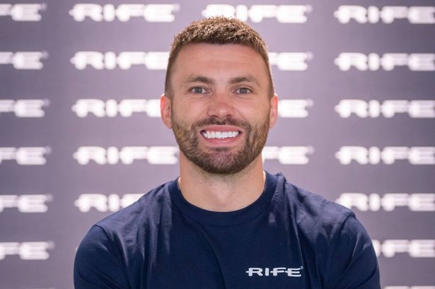 Stuart Dallas smiles as he has his picture taken