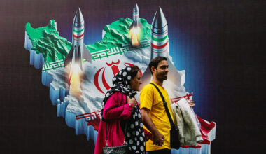 People walk past a mural depicting Iranian missiles in Tehran, Iran