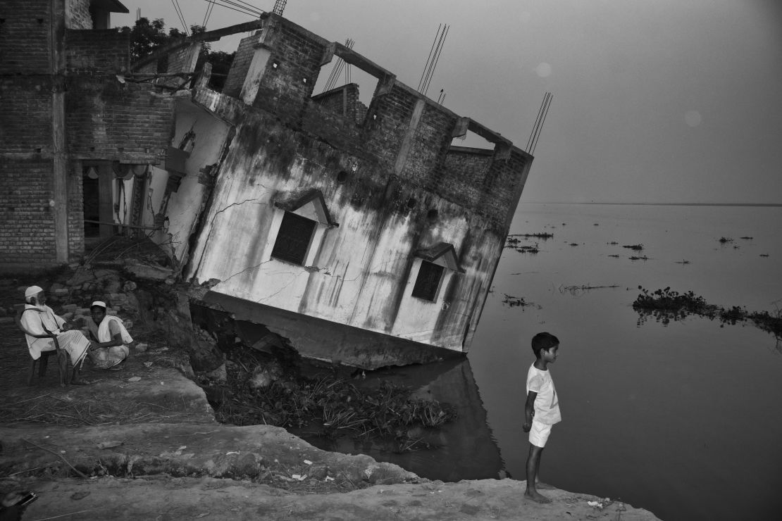A house falls into the River Ganges in West Bengal, India, due to erosion.