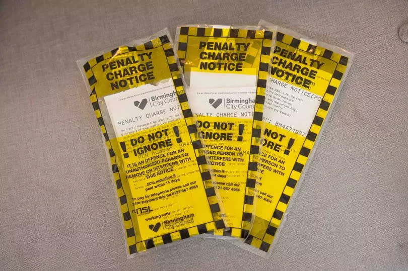 She's been fined three times for parking outside her own property on double yellow lines