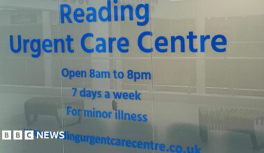 A glass window outside the centre which says in blue typeface: 'Reading Urgent Care Centre/Open 8am to 8pm/7 days a week/For minor illness".