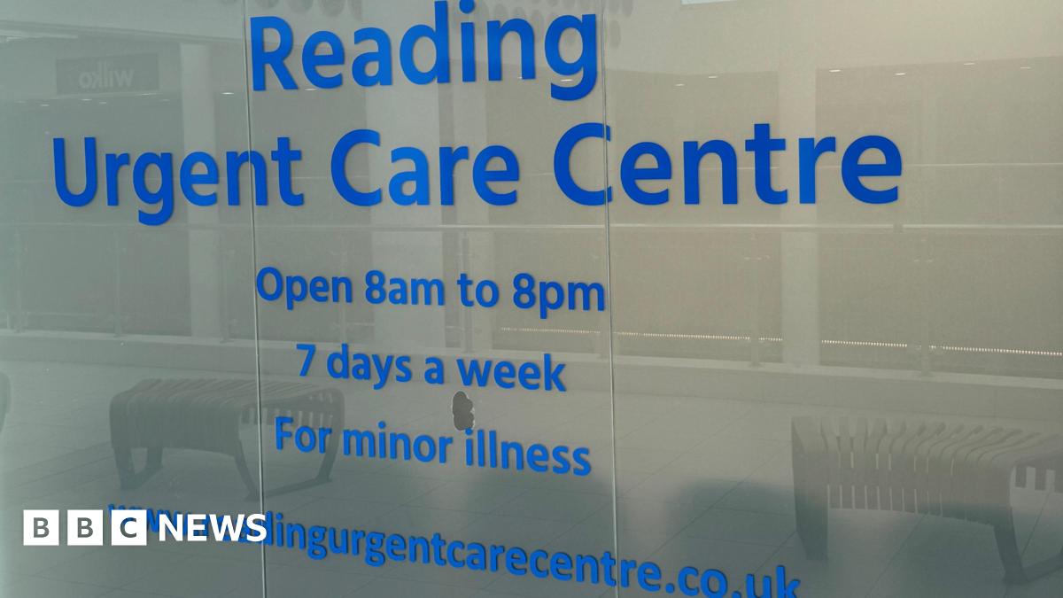 A glass window outside the centre which says in blue typeface: 'Reading Urgent Care Centre/Open 8am to 8pm/7 days a week/For minor illness".