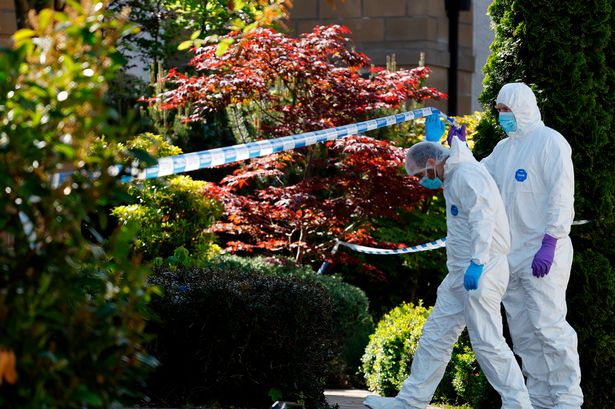-Police and forensics officers at David McMillan's house in Pitcairn Grove last week. 