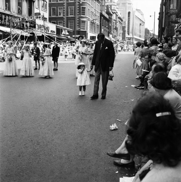Father and daughter take part in the Whit Walk. June 1960