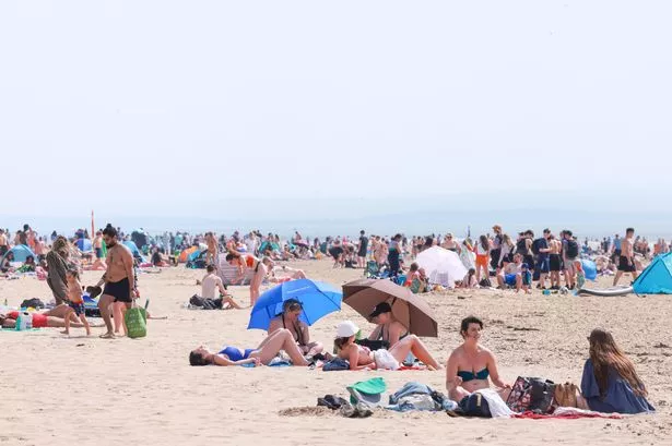 People enjoy the hot weather on Formby beach