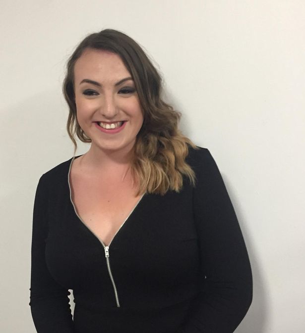A young lady wearing black smiling