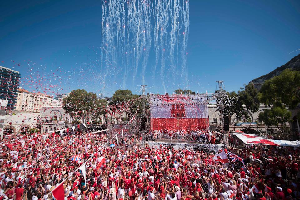 Rockets and streamers are seen during the National Day celebrations at Case Mates square in the British territory of Gibraltar on Sunday, Sept 10, 2017. The chief minister of Gibraltar says the British territory's post-Brexit future rests on strengthening its ties with the United Kingdom. (AP Photo/Marcos Moreno)