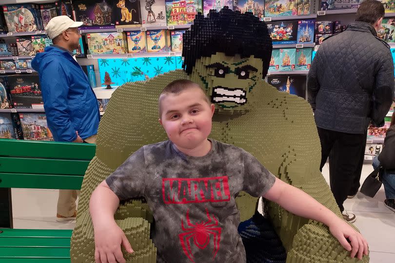 Harry Reid at the Lego store with a life size Hulk
