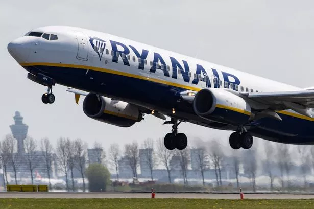 A Ryanair plane takes off from a runway 