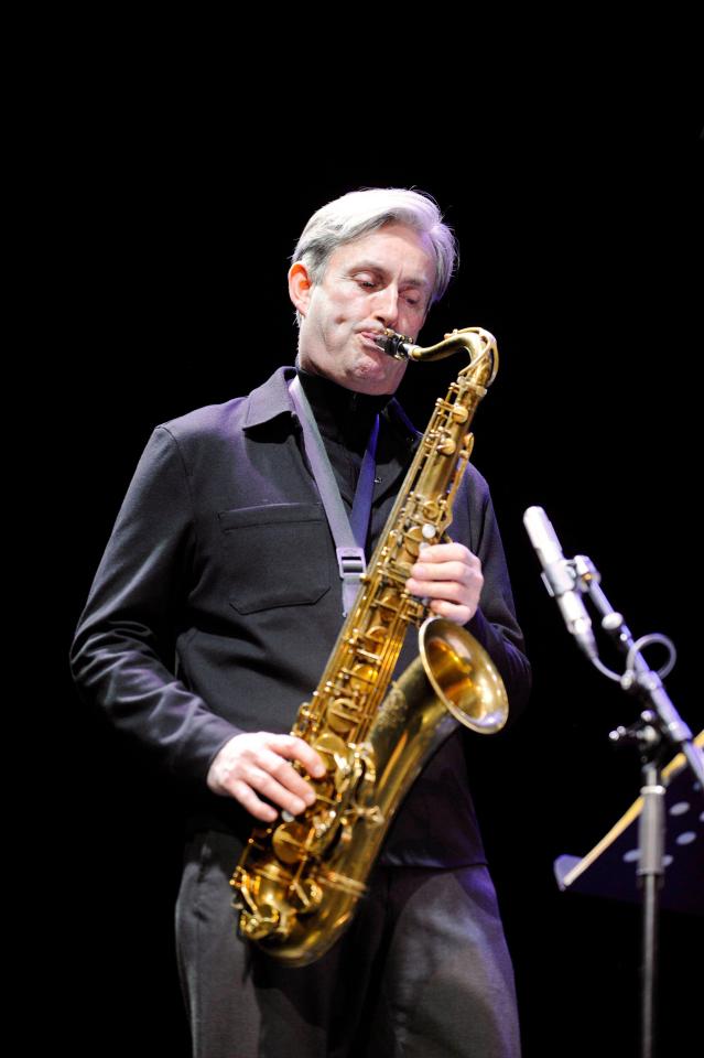 Tommy Smith, Scottish jazz saxophonist, holding saxophone.