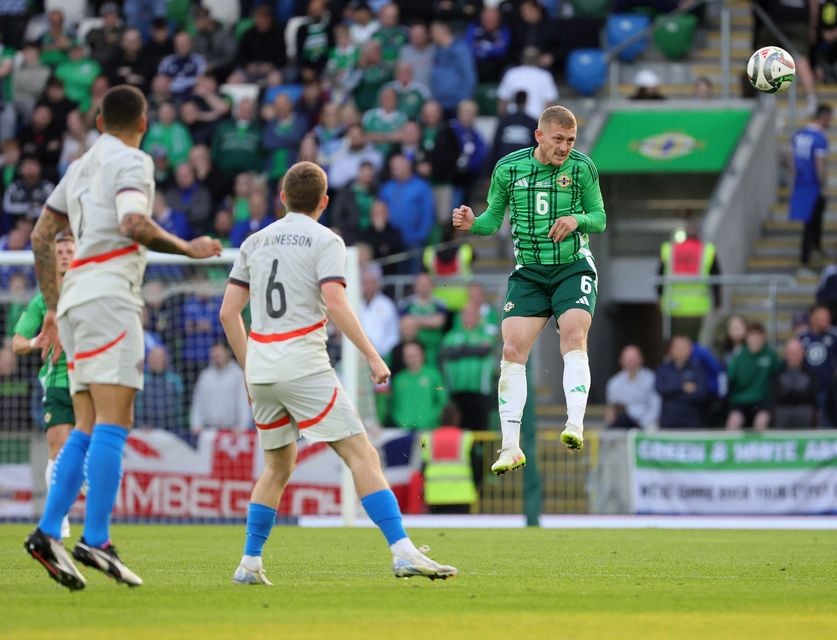 George Saville gets his head on the ball for Northern Ireland