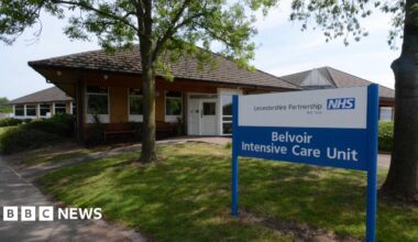 The exterior of the Belvoir Intensive Care Unit which is a single storey brick building with a blue NHS sign outside the front.
