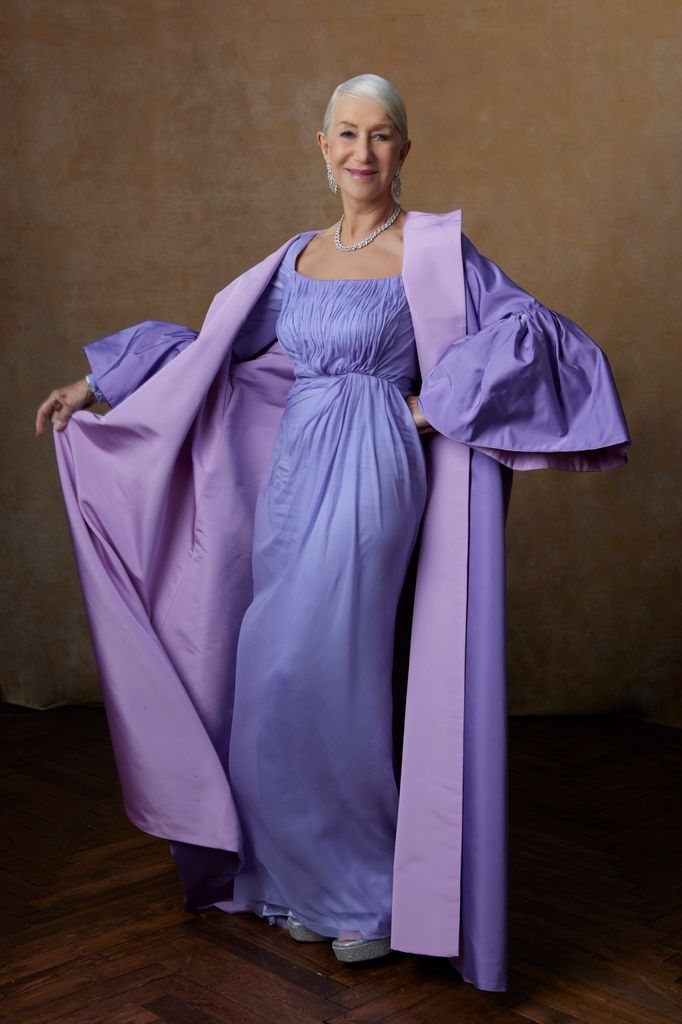 Helen Mirren posing in a lavender coloured dress 