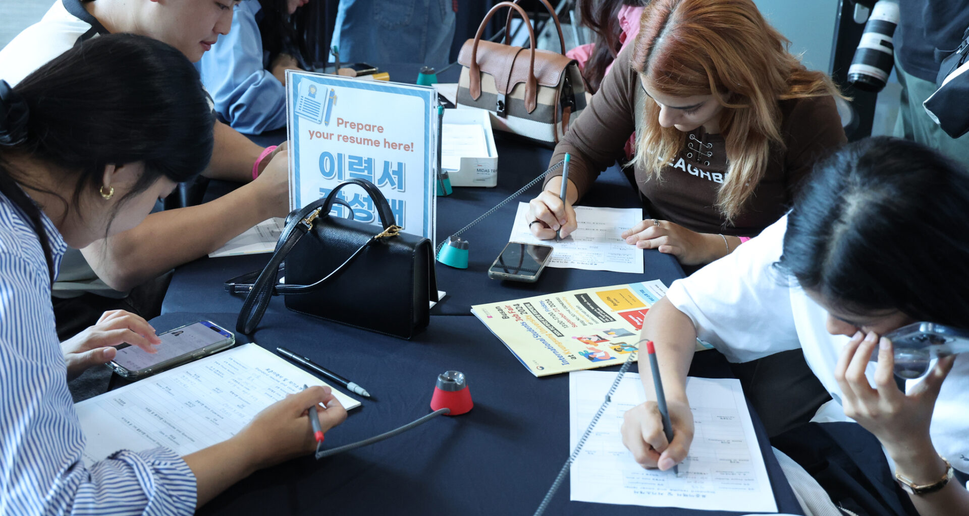International students fill in application forms at a job fair held in Busan on Sept. 27, 2024. [YONHAP]
