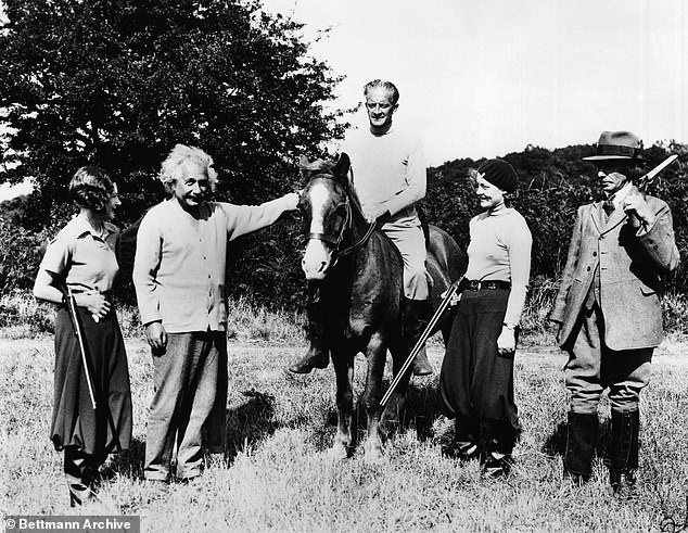 Whilst staying in Cromer, Einstein sunbathed and enjoyed milk from a nearby herd of goats, whilst being guarded all the time by women and men with guns. Above: The scientist poses with Locker-Lampson and his guards