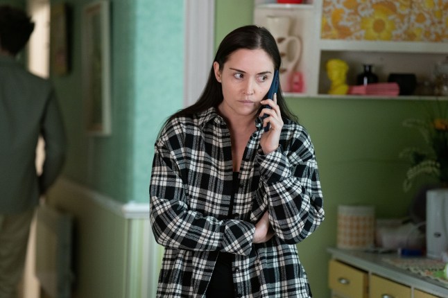 Lauren is on the phone in EastEnders