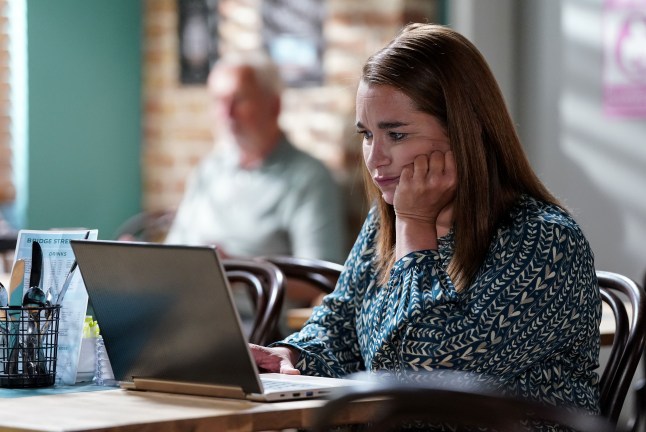 Vicki Fowler stares at her laptop in EastEnders