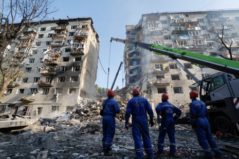 Ukrainian rescuers work at the site of an airstrike on a nine-story residential building in Kyiv, Ukraine.