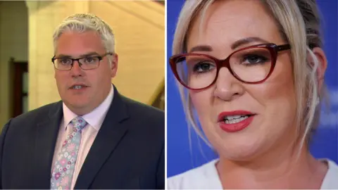 PA Media Gavin Robinson and Michelle O'Neill. Gavin has white hair, wearing glasses,  navy blazer, pink shirt and floral tie. Michelle has blonde hair tied back wearing glasses and a white top.