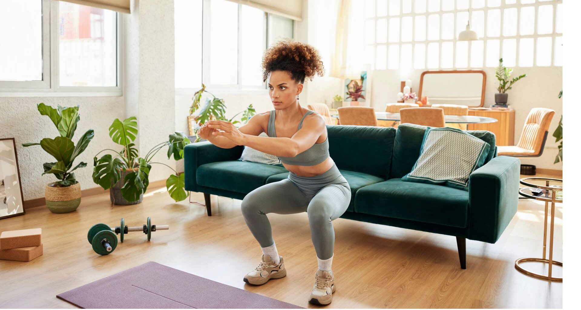 woman does bodyweight squat in her living room