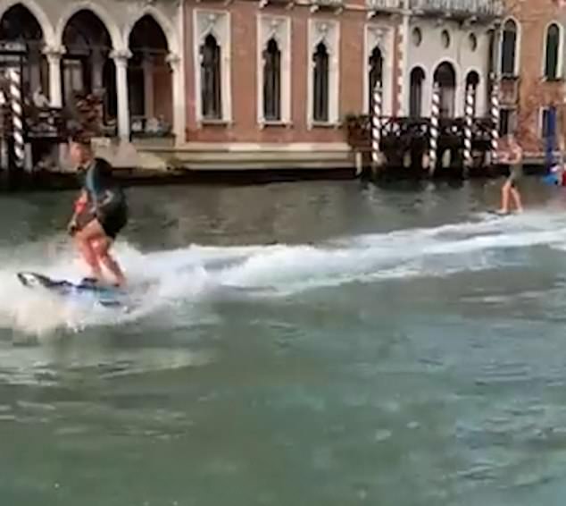 The duo zoomed past the city's famous monuments lining the canal as shocked locals watched on