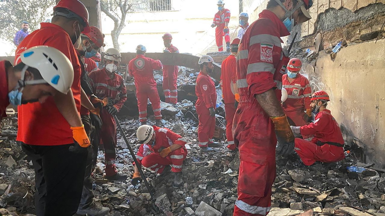 A photo made available by the Iranian Red Crescent Society (IRCS) shows rescuers at the site of an airstrike on a residential area in Tehran, Iran, 17 June 2025.