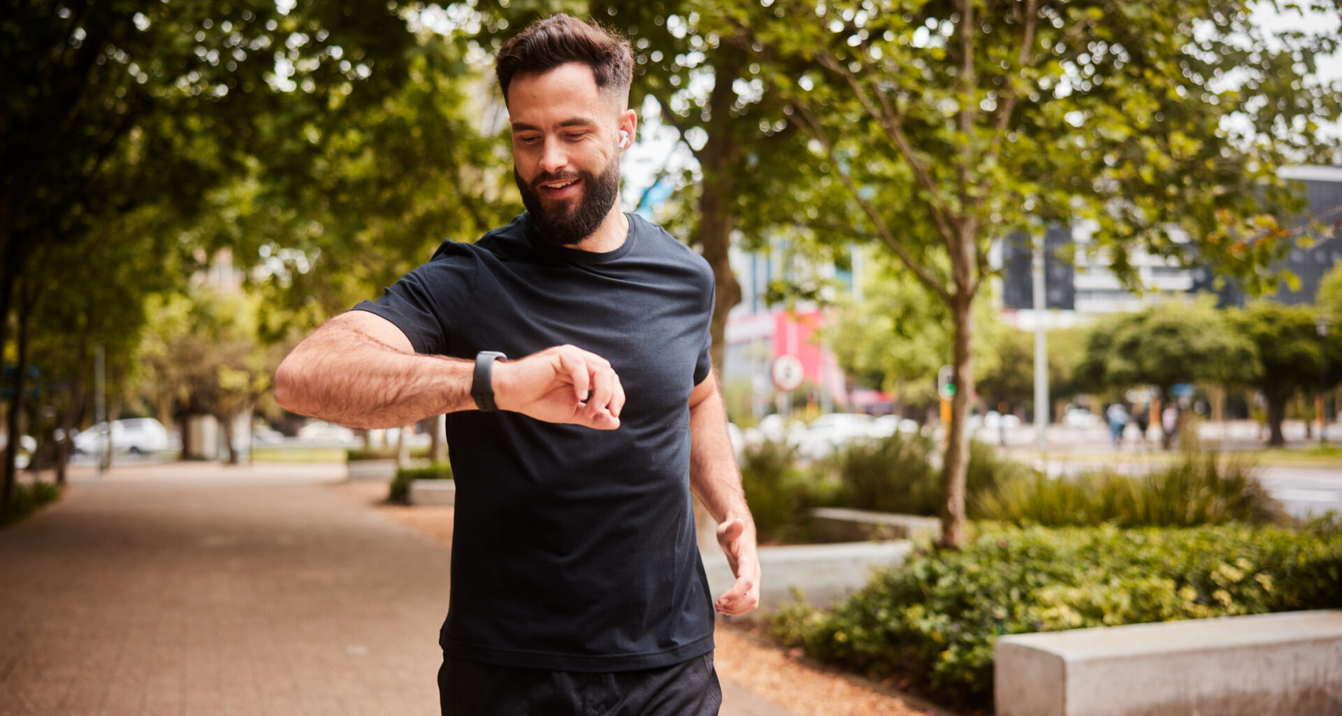 Male runner looking at his watch