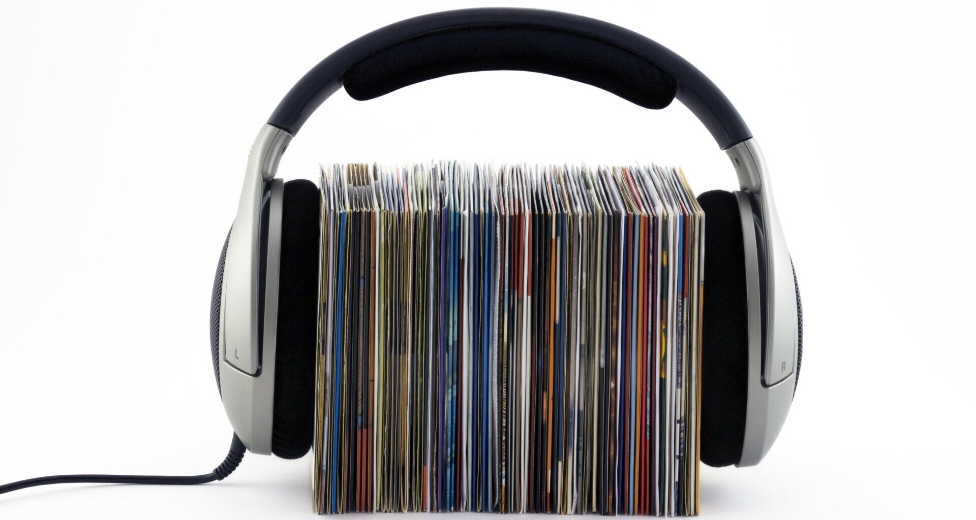 A stack of records with headphones on top of them