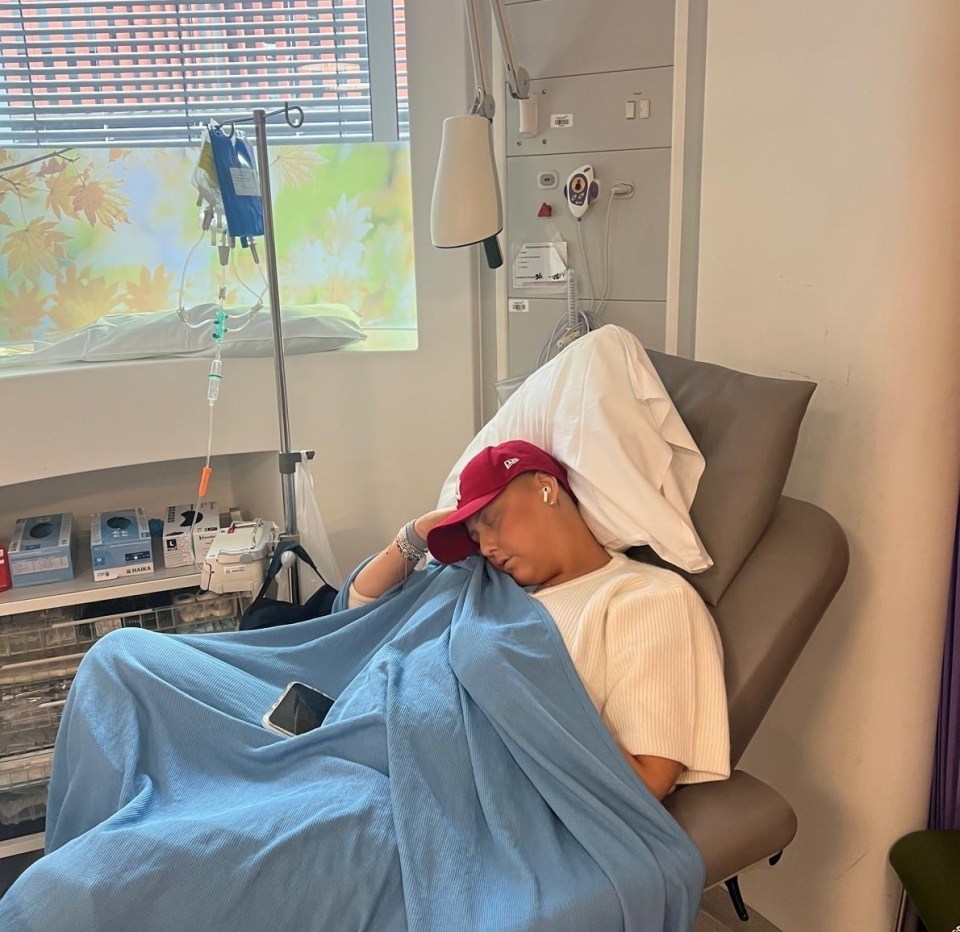 Woman sleeping in a hospital bed.