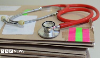 Stethoscope on top of a pile of folders.