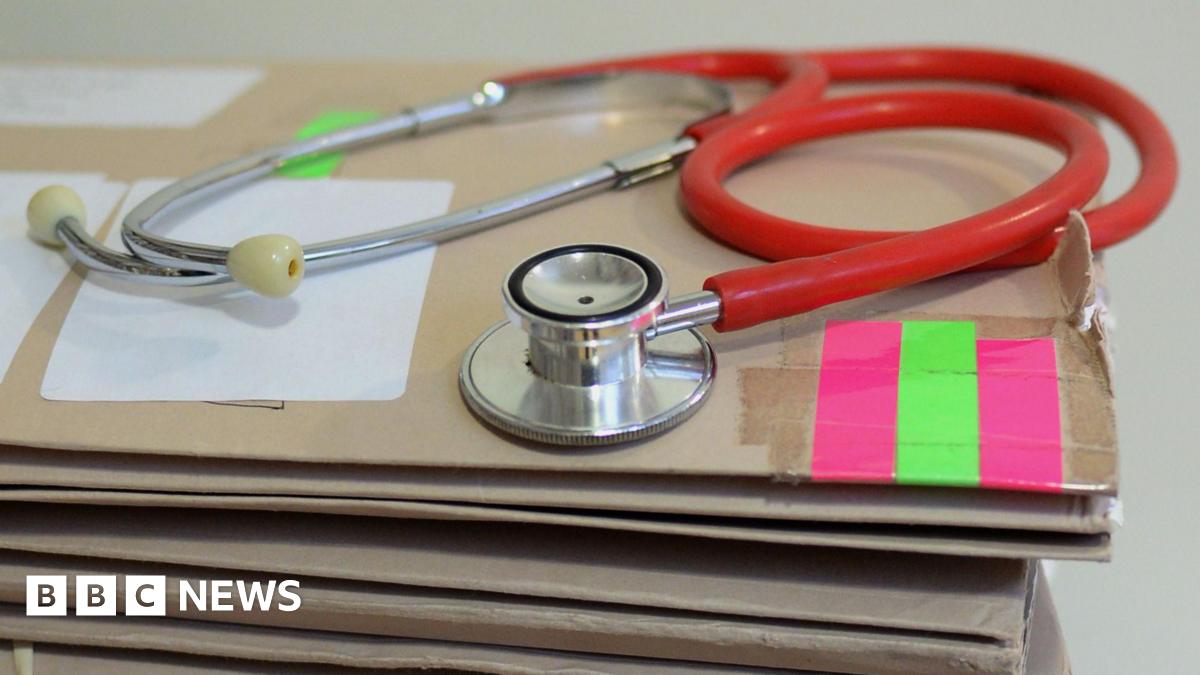 Stethoscope on top of a pile of folders.