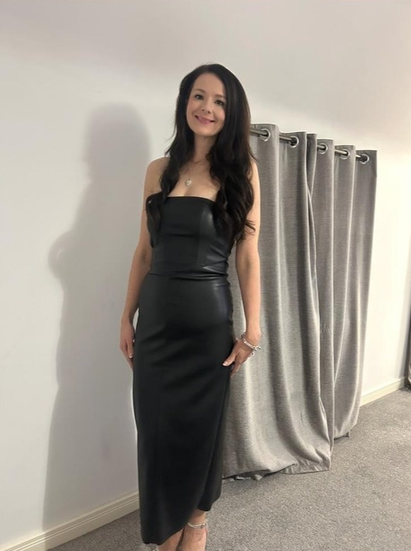 Woman in a black strapless dress.